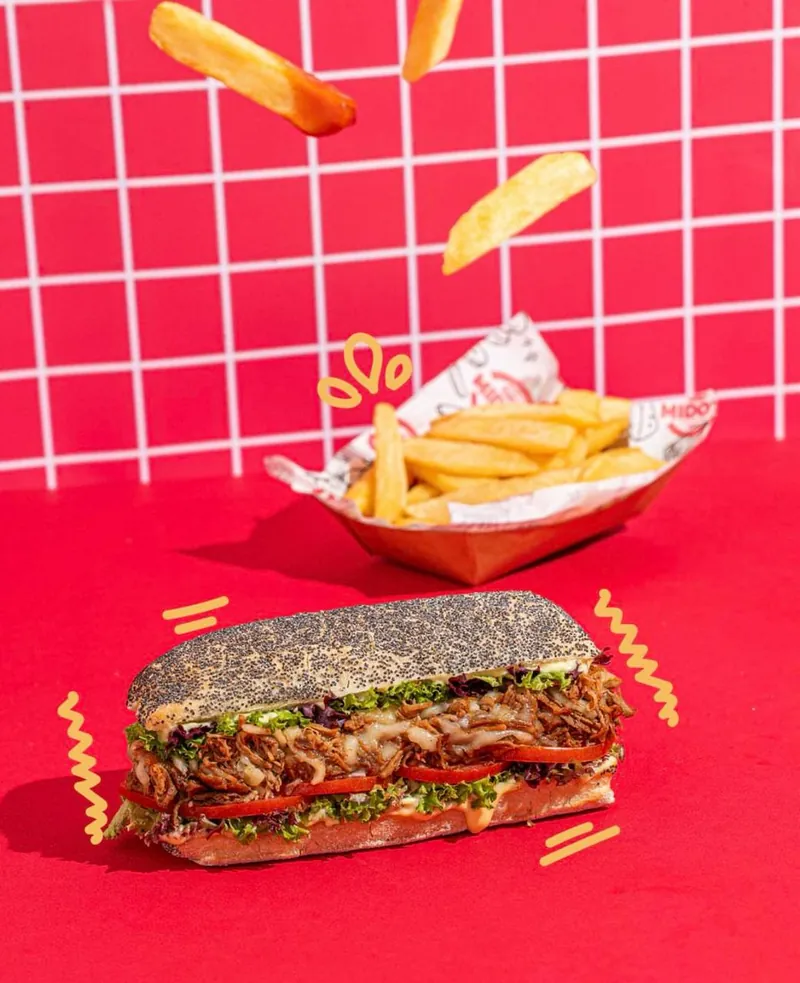 A Mido's sub and fries on the counter